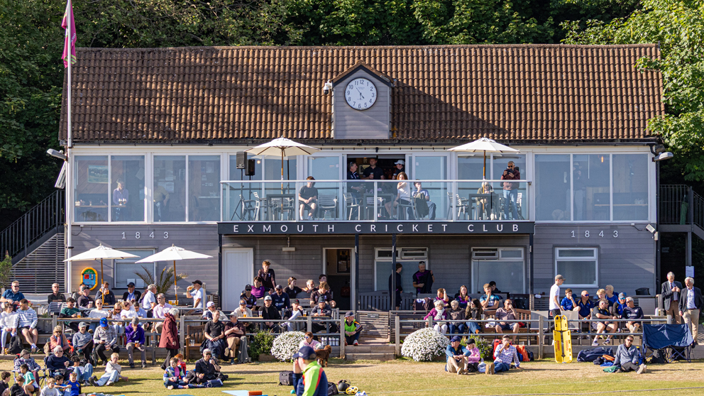 Cricket lovers soaking up the early evening sun on the terrace at Exmouth during the game between Devon and Somerset | Julen Beer