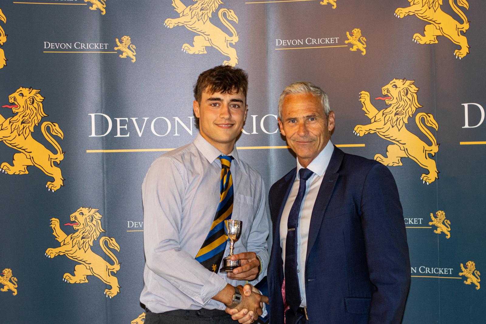 Harry Passenger is presented with the Under 18 Boys Player of the Year award by Andy Hurry.