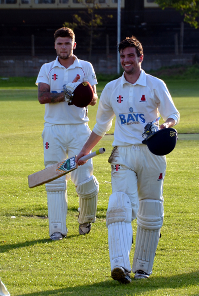 Richard Ashworth walks off with George Benton after steering Paignton to victory over North Devon