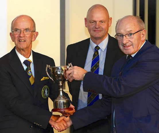 Alan Swift (right) receiving the Brian Hayter Trophy from DCB youth official Ted Ashman (left) and Brian's son Ian in 2013