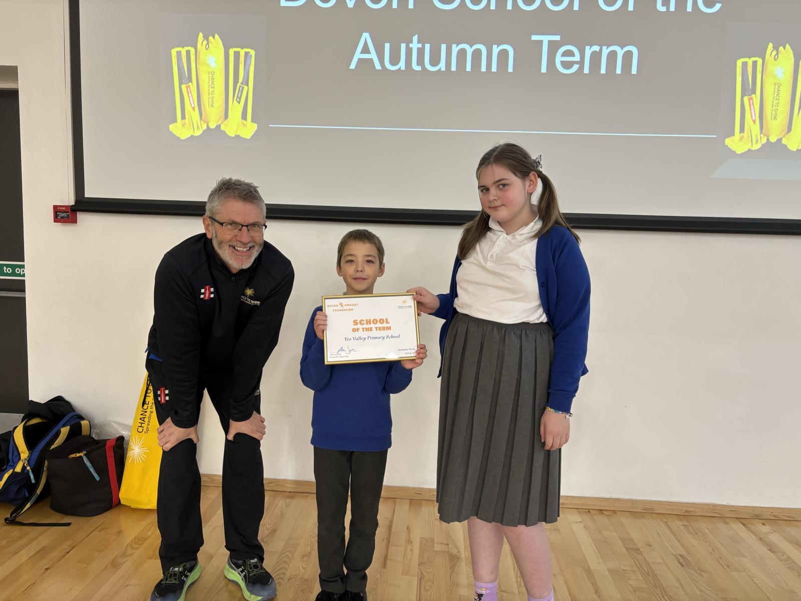 Oli (centre) and Amelia (right) being presented with the certificate by Martin Brice.