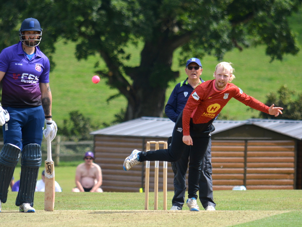 Stoke Gabriel's Dan Bullock bowling under the watchful gaze off Cullompton captain Brendon Parr