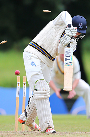 Bails fly! Devon's Zak Bess is bowled by Henry Davies